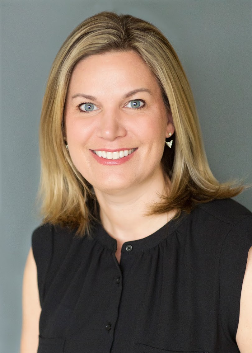 Professional woman smiling confidently in a business portrait.