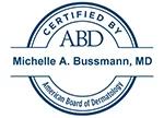 A blue and white certification seal indicating certified by abd – michelle a. bussmann, md suggesting that dr. bussmann is certified by the american board of dermatology.