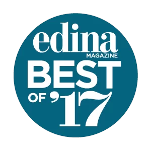 Award emblem for edina magazine best of 2017 featuring stylized text and graphics on a circular dark blue background.