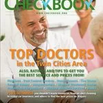 A smiling male doctor with a stethoscope around his neck on the cover of twin cities checkbook magazine, featuring an article about top doctors in the twin cities area.