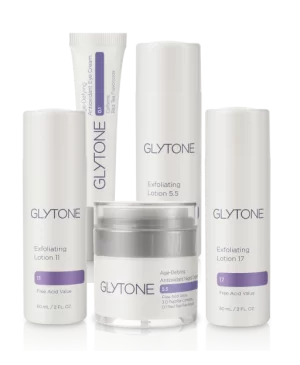 A collection of glytone skincare products, featuring exfoliating lotions and an anti-aging cream.